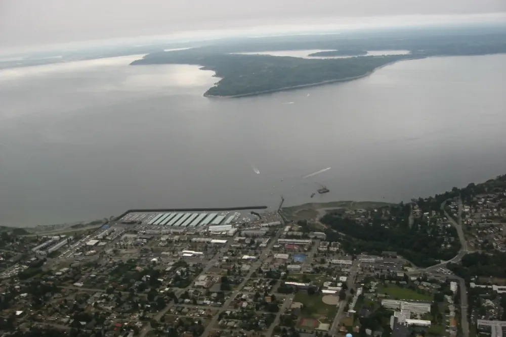 Aerial view of the Des Moines marina and waterfront with Maury Island beyond, Des Moines, Washington