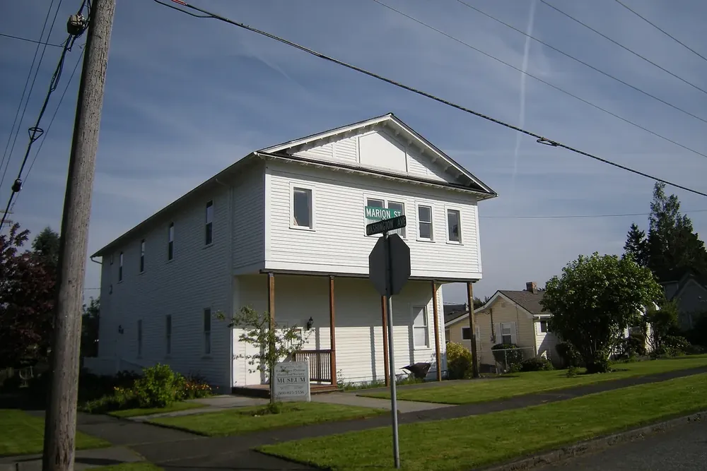 Enumclaw Plateau Historical Society Museum, a white two-story building, in Enumclaw, Washington